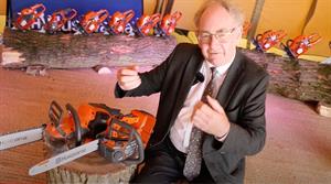 Howard Drury with two Husqvarna chainsaws